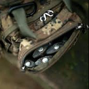 Close-up of a tactical pouch with camouflage pattern and visible brand logo.